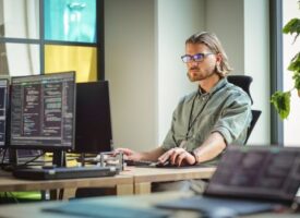 Male Data Scientist Coding on Desktop Computer in Creative Office Space. Caucasian Man Scraping Digital Information From Opened Sources in Internet For Artificial Inteligence Software Development.